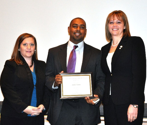 John Foster, Fearless, receives the chapter’s semi-annual Young AFCEAN award from Sarah Dabney (l), chapter Young AFCEAN president, and Kauffman.